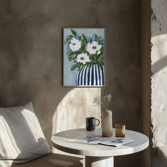 Floral painting on a wall above a table with a cup and vase.