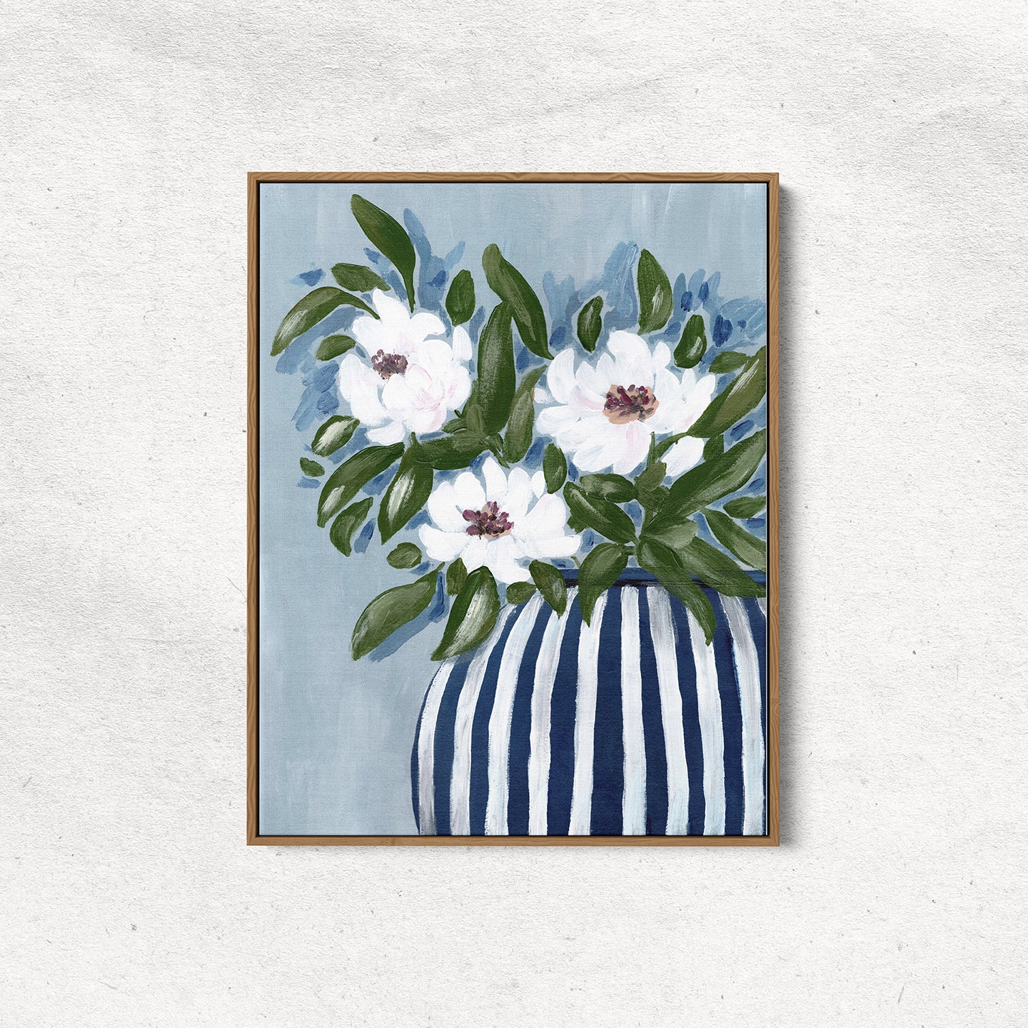 Framed artwork of white flowers in a striped vase on a light gray wall.