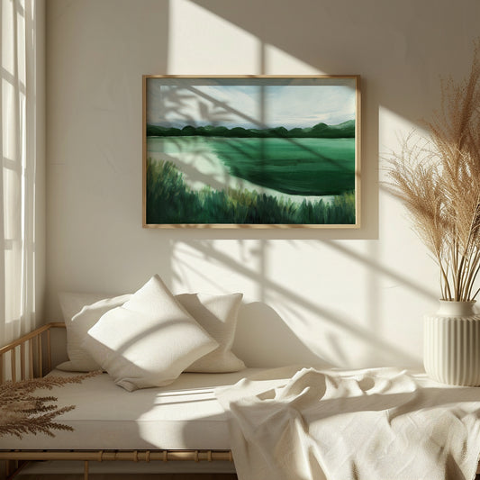 Framed landscape painting on a wall above a bed with white bedding and pillows.