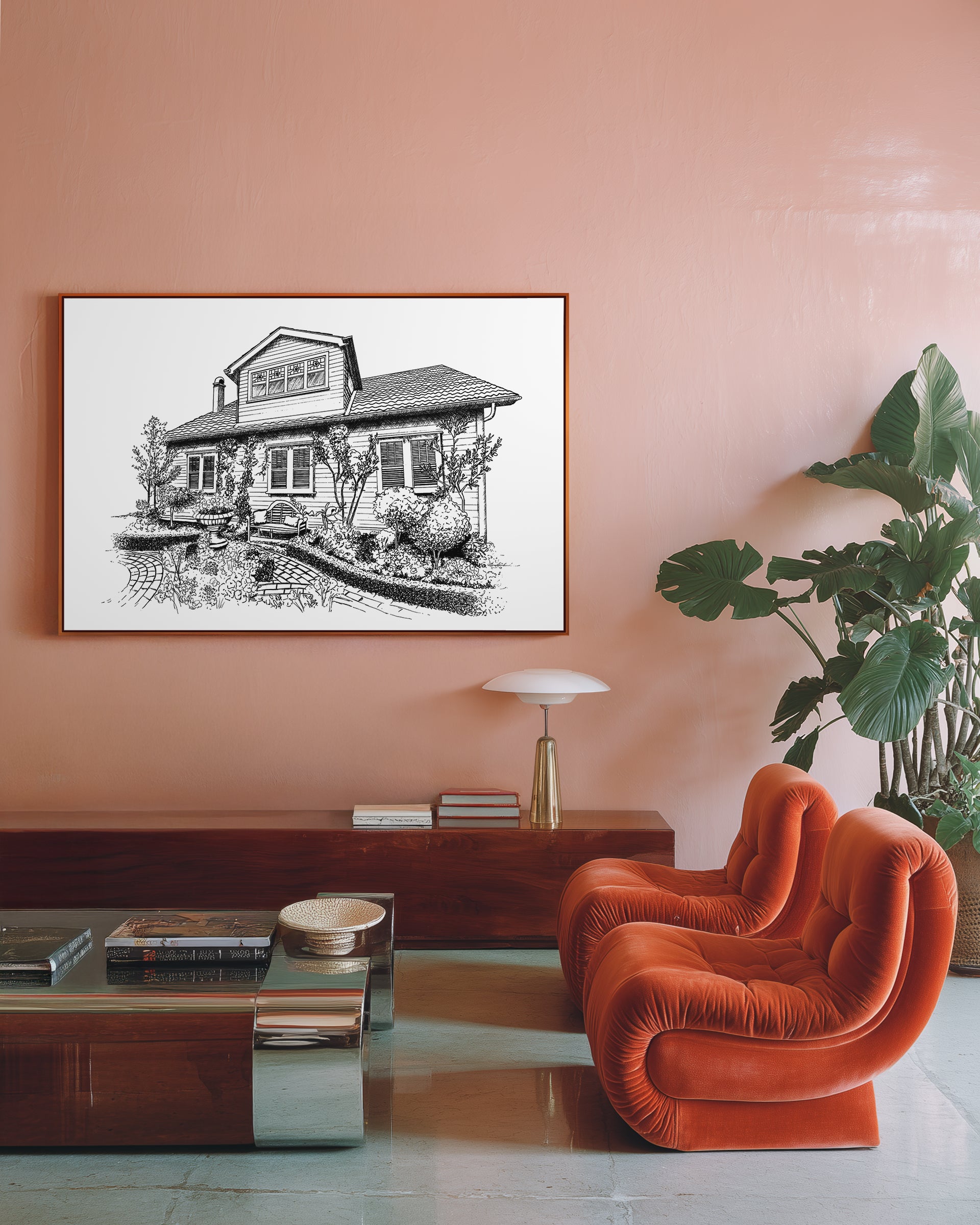 Living room with orange chair, pink wall, and framed black and white artwork.