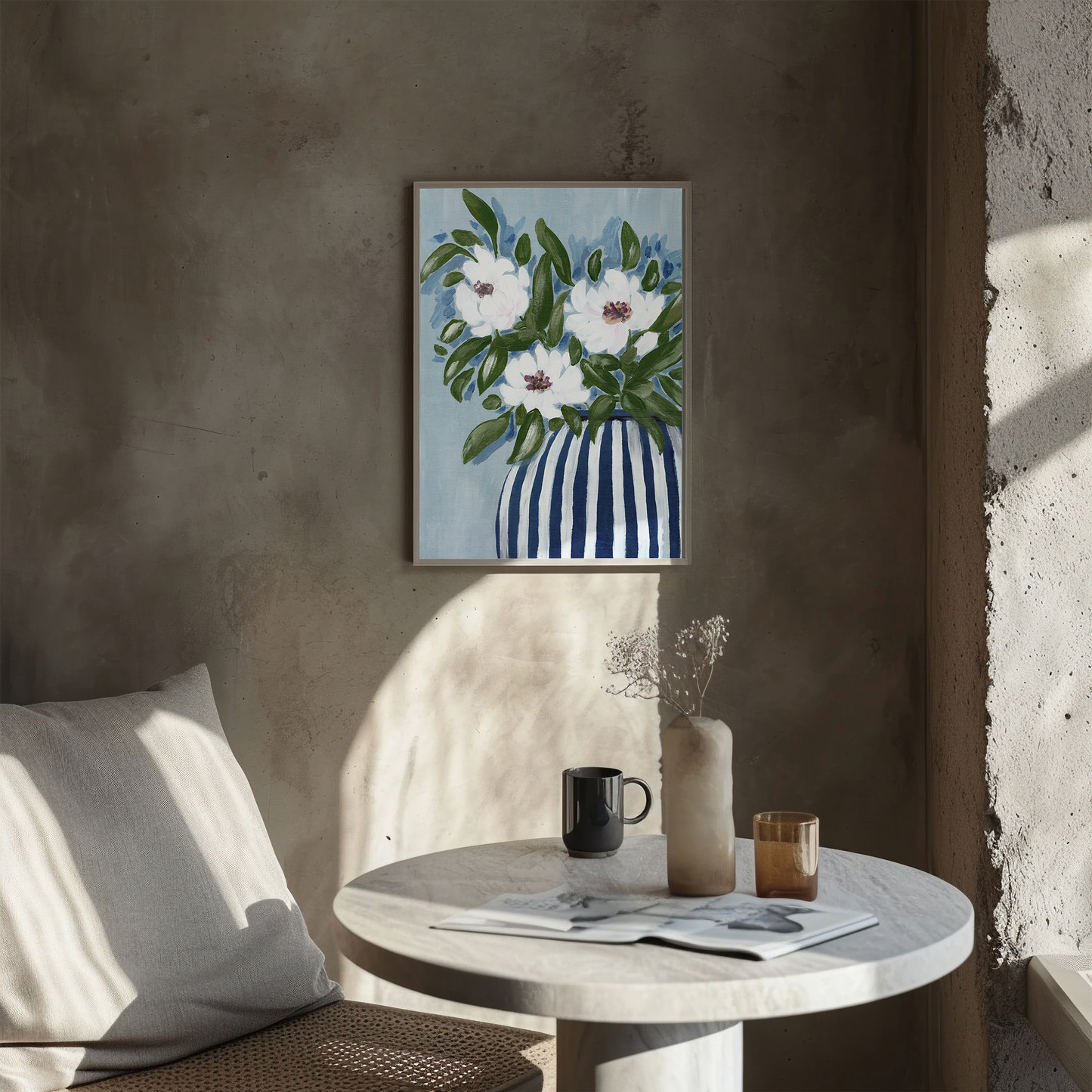 Floral painting on a wall above a table with a cup and vase.